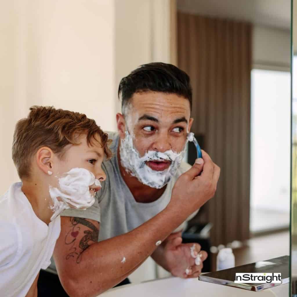 Father and son shaving infront of a mirror under title What Type of Mirror is Used in Bathrooms